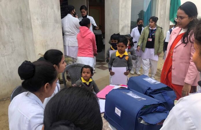 गुरुकुल स्कूल में बच्चों का स्वास्थ्य परीक्षण करती चिकित्सकीय टीम।